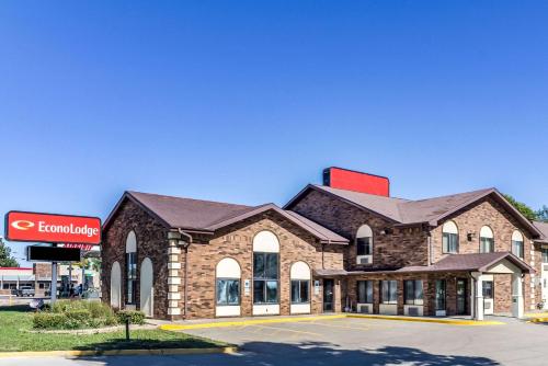 a large brick building with a gas station at Econo Lodge Sioux Falls North in Sioux Falls