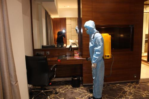 a mannequin standing in front of a desk in a hotel room at Ramada by Wyndham Gandhidham Shinay in Gandhidham