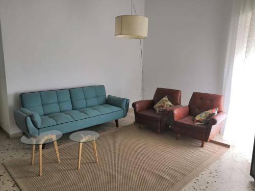 a living room with a couch and two chairs at Zibibbo Apartment in Pantelleria