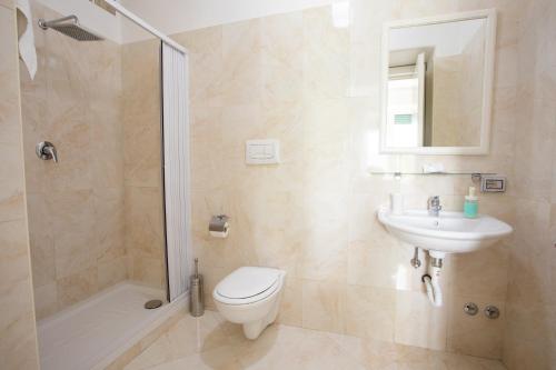 a bathroom with a toilet and a sink and a shower at Blunotte Potenza in Potenza