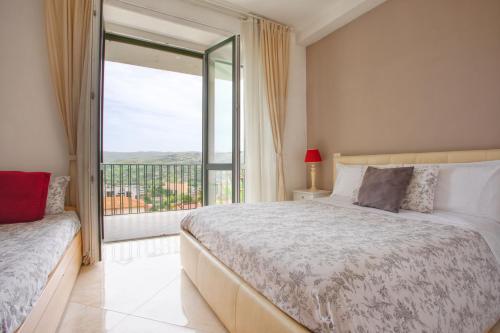 a bedroom with a bed and a large window at Blunotte Potenza in Potenza