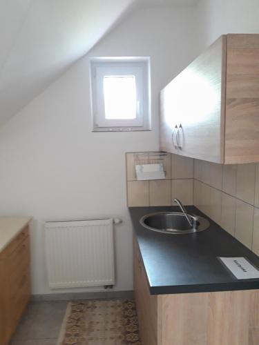 a small kitchen with a sink and a window at TIC Hervartov in Hervartov