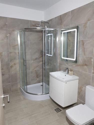 a bathroom with a shower and a toilet and a sink at RELAX ALEZZI BEACH RESORT in Mamaia Sat/Năvodari