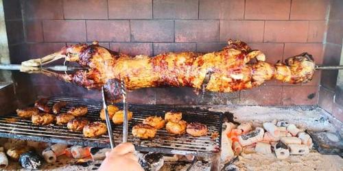 a person is cooking food on a grill at Afroditi in Paralia Katerinis