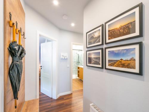 a hallway with four pictures on the wall at OSTSEELOFT BINZ - Villa Amanda WG 08 in Binz