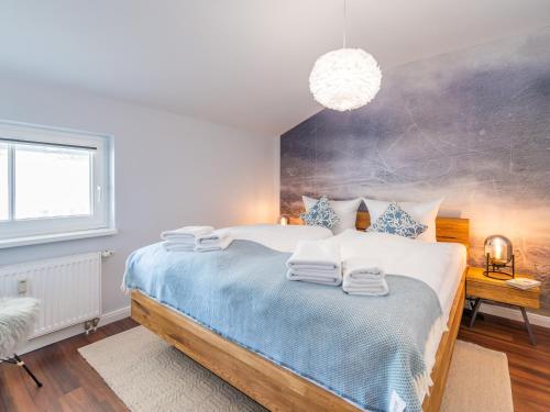 a bedroom with a large bed with towels on it at OSTSEELOFT BINZ - Villa Amanda WG 08 in Binz