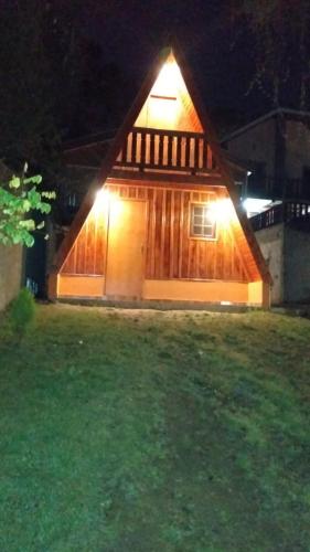 a house with a light on the side of it at night at Chalé - Sossego 1 in Campos do Jordão