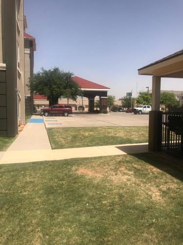 a sidewalk in front of a building with a parking lot at La Quinta by Wyndham Abilene Mall in Abilene
