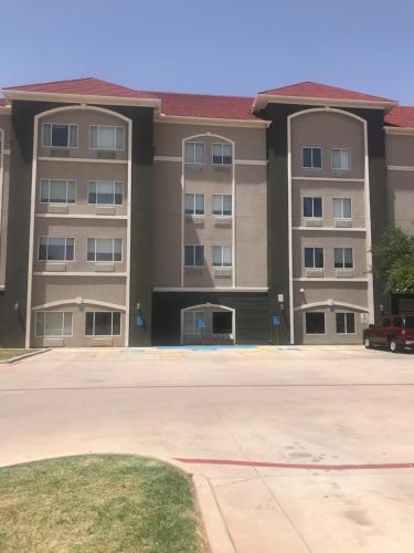 a large apartment building with a parking lot at La Quinta by Wyndham Abilene Mall in Abilene
