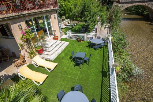 an aerial view of a patio with chairs and tables at Hôtel Doussière - Restaurant l'Alicanta in Le Rozier