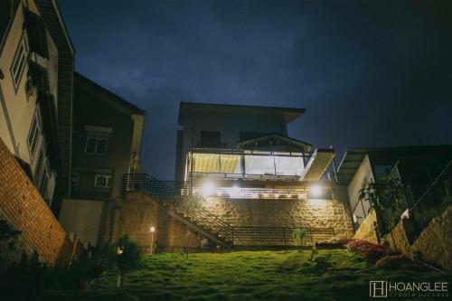 a house with lights on the side of it at night at Lux Nest Villa Đà Lạt in Da Lat