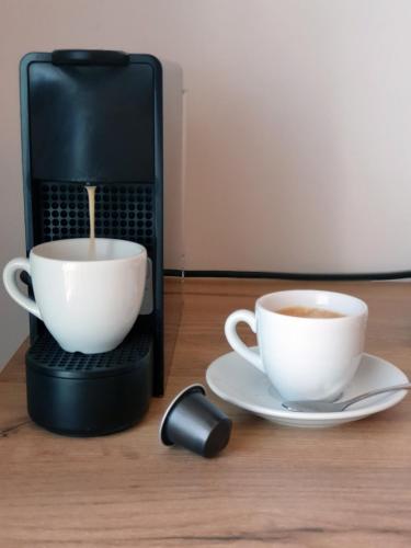 a coffee maker with two cups of coffee on a table at Hypnos Boutique Hotel in Nicosia