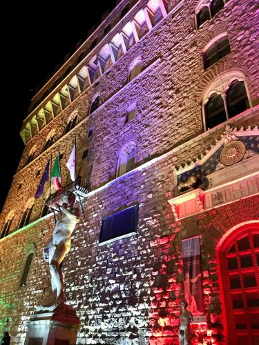 a large brick building with christmas lights on it at Capri Moon Guest House in Florence