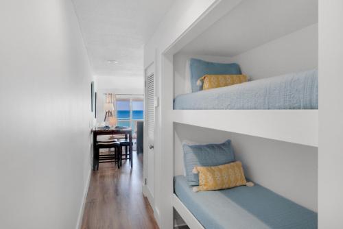 a bedroom with two bunk beds and a desk at Mistral Unit 18 in Santa Rosa Beach