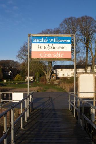 a sign on a bridge over a road at Ferienhaus Schleiharmonie in Ulsnis
