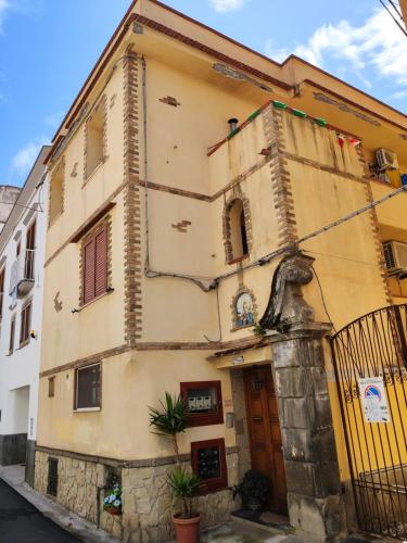 a yellow building with a gate and a building at B&B Mediterranea in Meta