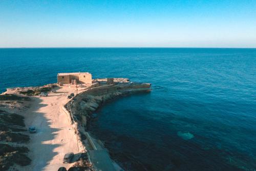 an aerial view of a beach and the ocean at Sunset Seaview Apartments in Marsalforn
