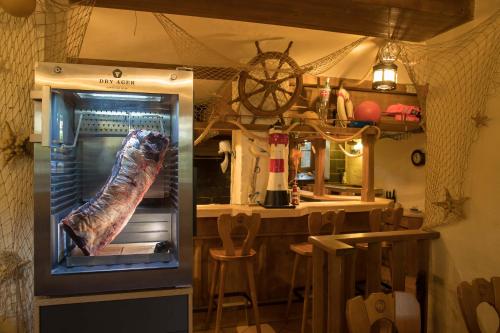 a large fish in an open refrigerator in a kitchen at Parkhotel Plauen in Plauen
