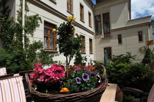a basket of flowers on a table in front of a building at Parkhotel Plauen in Plauen