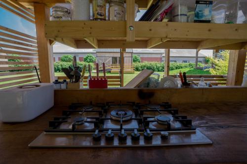a kitchen with a stove top in the middle of a room at Horse Glamping Park in Cirkovce