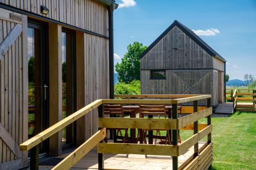 a building with a deck and a barn at Horse Glamping Park in Cirkovce
