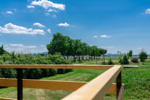 a wooden bench in a park with trees at Horse Glamping Park in Cirkovce