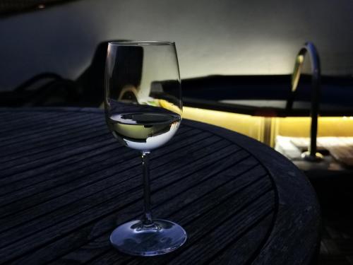 a glass of wine sitting on top of a table at Casa Ayo in Frigiliana