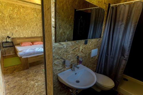 a bathroom with a sink and a bed in a room at Horse Glamping Park in Cirkovce