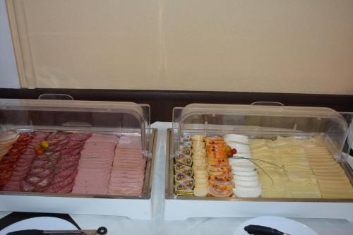 two plastic containers of food in a refrigerator at Lotus Family Hotel - Free Parking in Sunny Beach