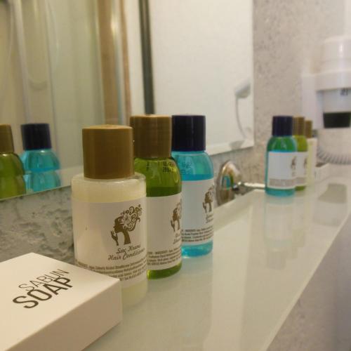 three bottles of soap sitting on a bathroom sink at Grand Antalya Hotel in Antalya