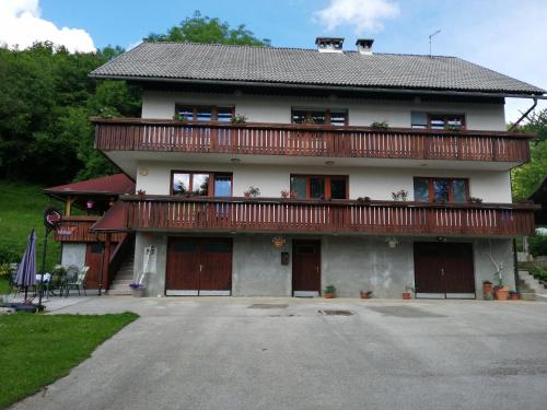 a large house with a balcony on top of it at Apartmaji Pika in Cerklje na Gorenjskem