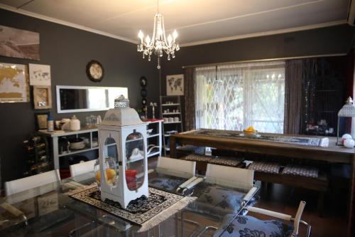 a dining room with a table with a bird feeder on it at Eagle's Nest in Barberton
