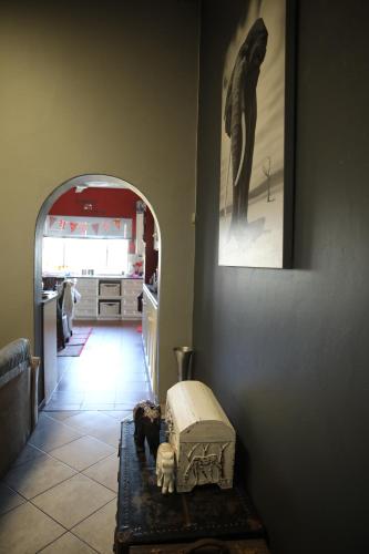 a hallway with a dog sitting on a rug in a kitchen at Eagle's Nest in Barberton