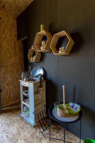 a room with a table and shelves on the wall at Horse Glamping Park in Cirkovce