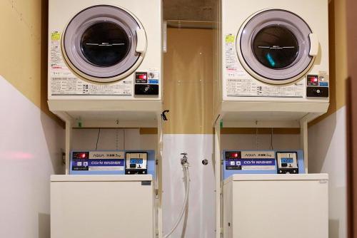 two washers and dryers in a utility room with at THE STAY WAKKANAI in Wakkanai