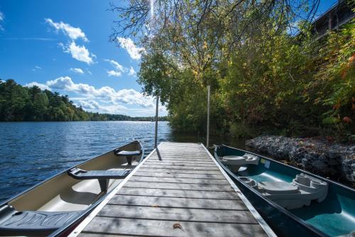 a boat tied up to a dock on a lake at Ramada by Wyndham Ottawa On The Rideau in Ottawa