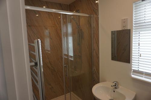 a bathroom with a shower and a sink at Deluxe Lundy View Villa With Sea Views in Westward Ho