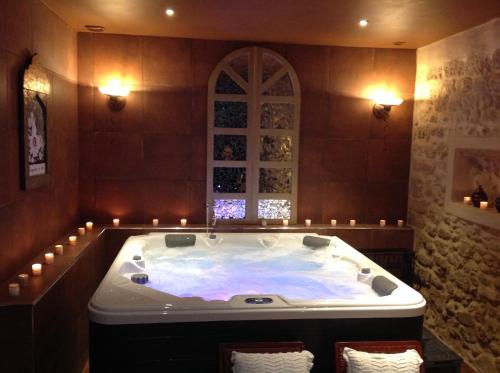a large bath tub in a room with candles at Chateau de Murviel in Murviel
