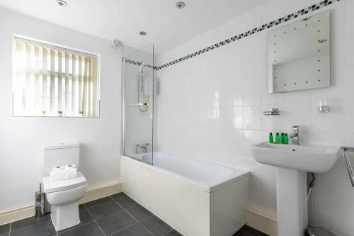 a white bathroom with a sink and a toilet at No 1 - LARGE 1 BED NEAR SEFTON PARK AND LARK LANE in Liverpool