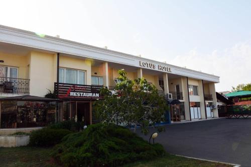 a building with a sign that reads lions hotel at Lotus Family Hotel - Free Parking in Sunny Beach