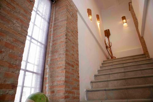 a stair case in a building with a brick pillar at Caserío Lo Bulle in Oria