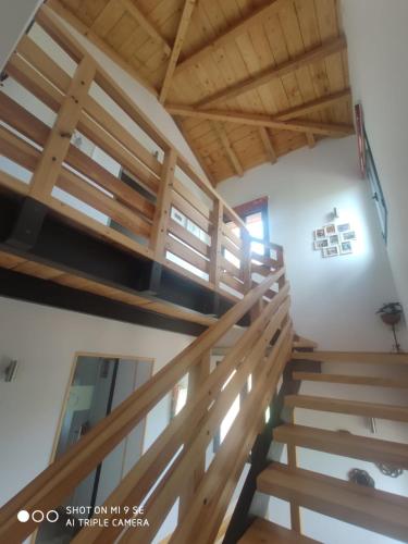 a staircase in a house with wooden ceilings at Finca La Calancha in Cuerva