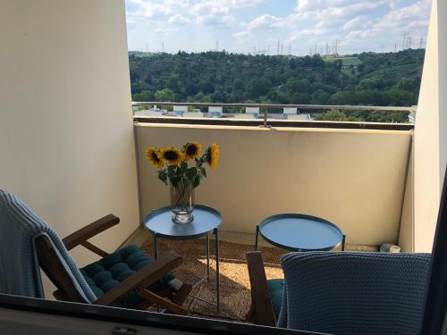 a vase of flowers on a table on a balcony at großes Appartement mit Aussichtsbalkon in Ludwigsburg