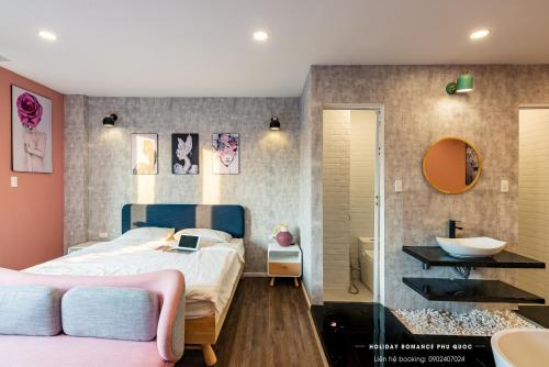 ein Schlafzimmer mit einem Bett und ein Badezimmer mit einem Waschbecken in der Unterkunft Minimalist & Modern Apartment III in Phu Quoc