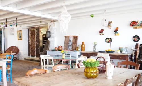 a dining room with a wooden table and chairs at Hôtel Lido Beach in Hyères