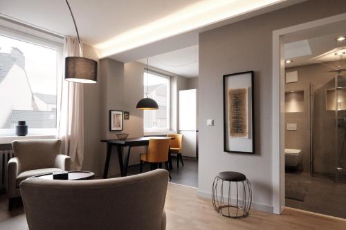 a living room with a table and chairs at SAXX Apartments "Goldberg Karree" in Hagen