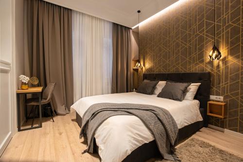 a bedroom with a bed and a desk in it at Harbour Residence Rooms in Rijeka