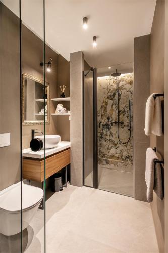 a bathroom with a shower and a toilet and a sink at Harbour Residence Rooms in Rijeka