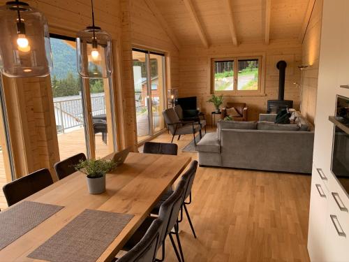 a living room with a table and a couch at Chalet Rotheheim in Kirchbach