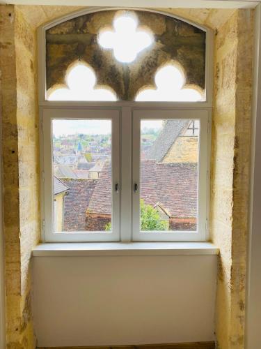 an open window with a view of a city at Sarlat.Catalina in Sarlat-la-Canéda